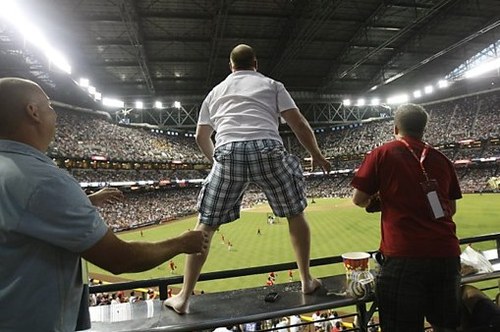 Keith Carmickle of Kingman, Ariz.,, stands - Media (3 of 4) Fan nearly falls from stands during homer.jpg